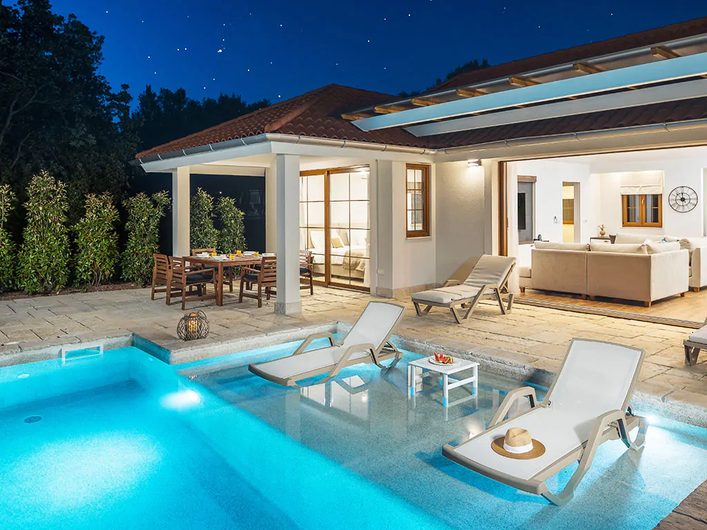 camping-mon-perin-beach-front-villa-porto-bus-exterior-pool-terrace-night-view-2