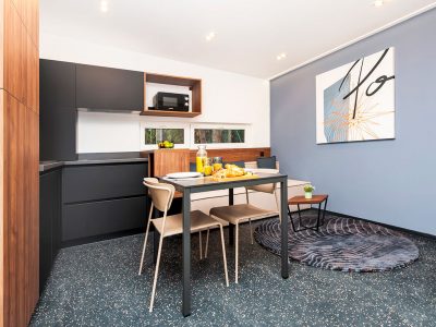 porton-biondi-nature-hideouts-mobile-homes-couple-interior-dining-table