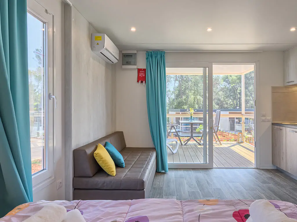 campsite-santa-marina-mobile-home-romantic-suite-interior-kitchen-living-room-couch