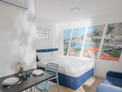 elements-camping-selce-studio-mobile-home-interior-bedroom-double-bed-sofa