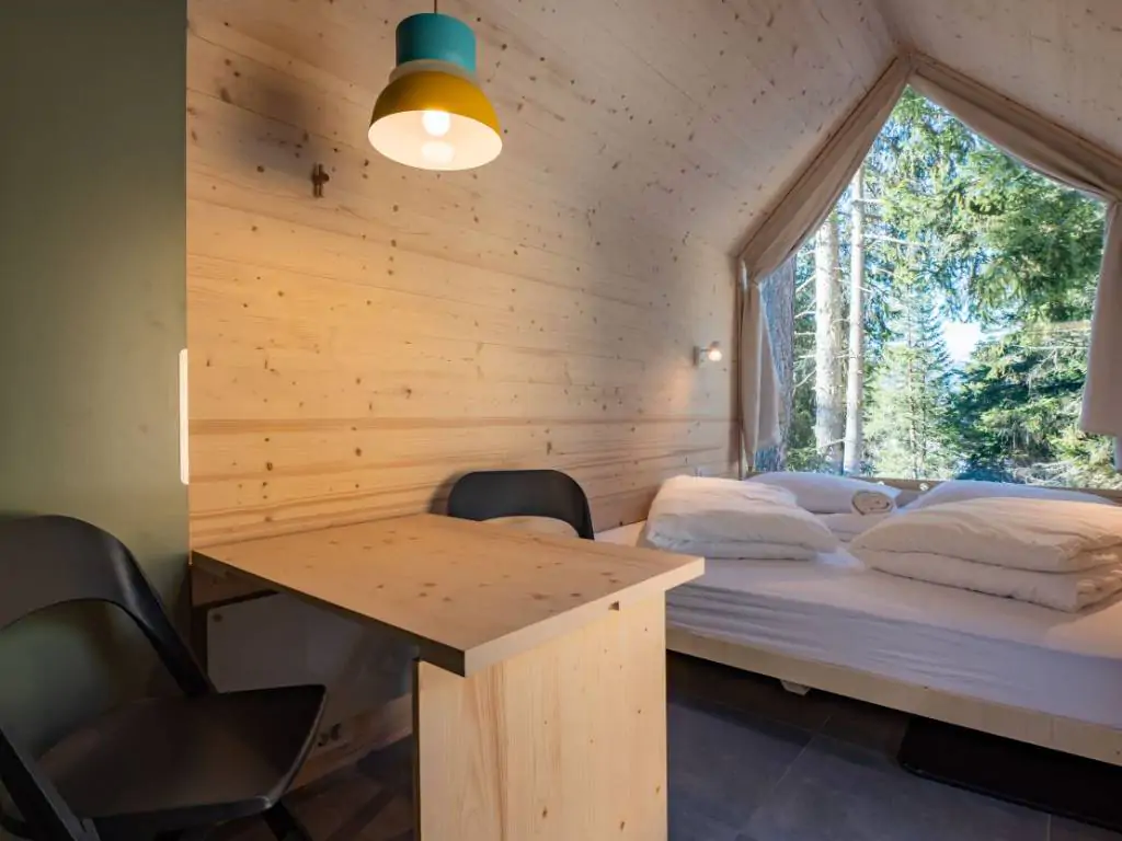 sass-dlacia-forest-cabin-interior-bedroom-pillows-mountain-view-relax