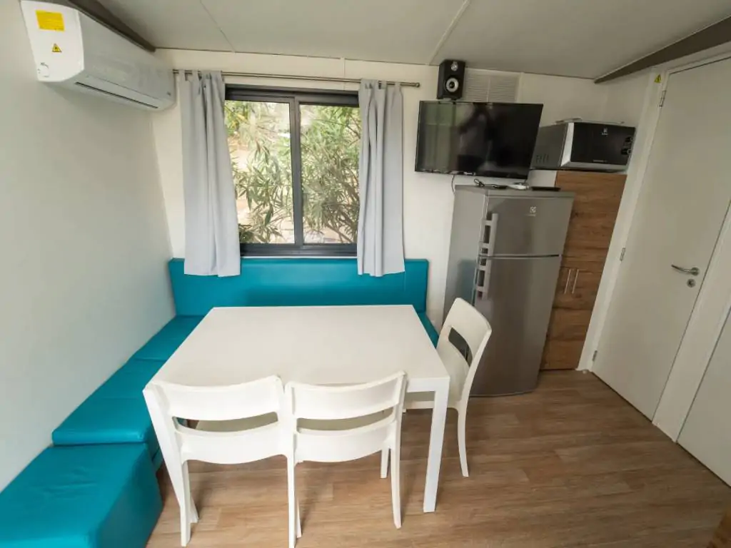 vallicella-glamping-resort-cottage-next-l-living-room-with-dining-table