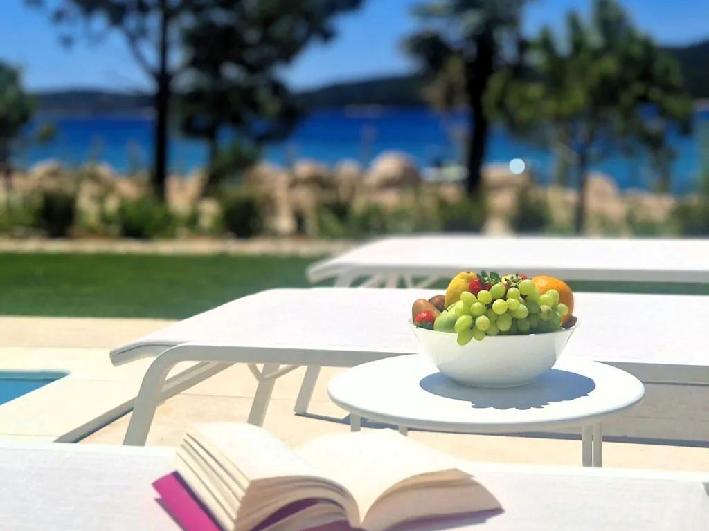 amadria-park-sibenik-mobile-home-exterior-pool-sun-beds-fruit-sea-view