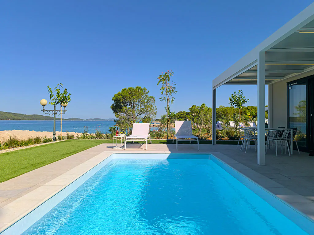 amadria-park-sibenik-mobile-home-exterior-pool-sun-beds-view
