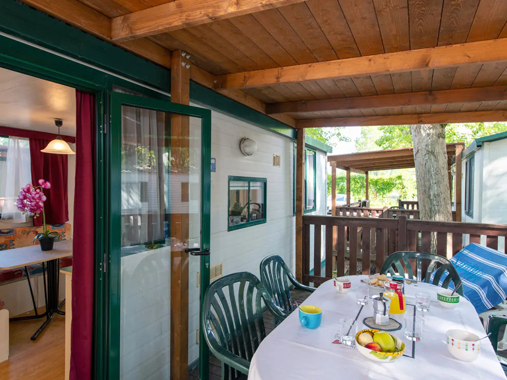 camping-village-punta-navaccia-mobile-home-exterior-terrace-table-view