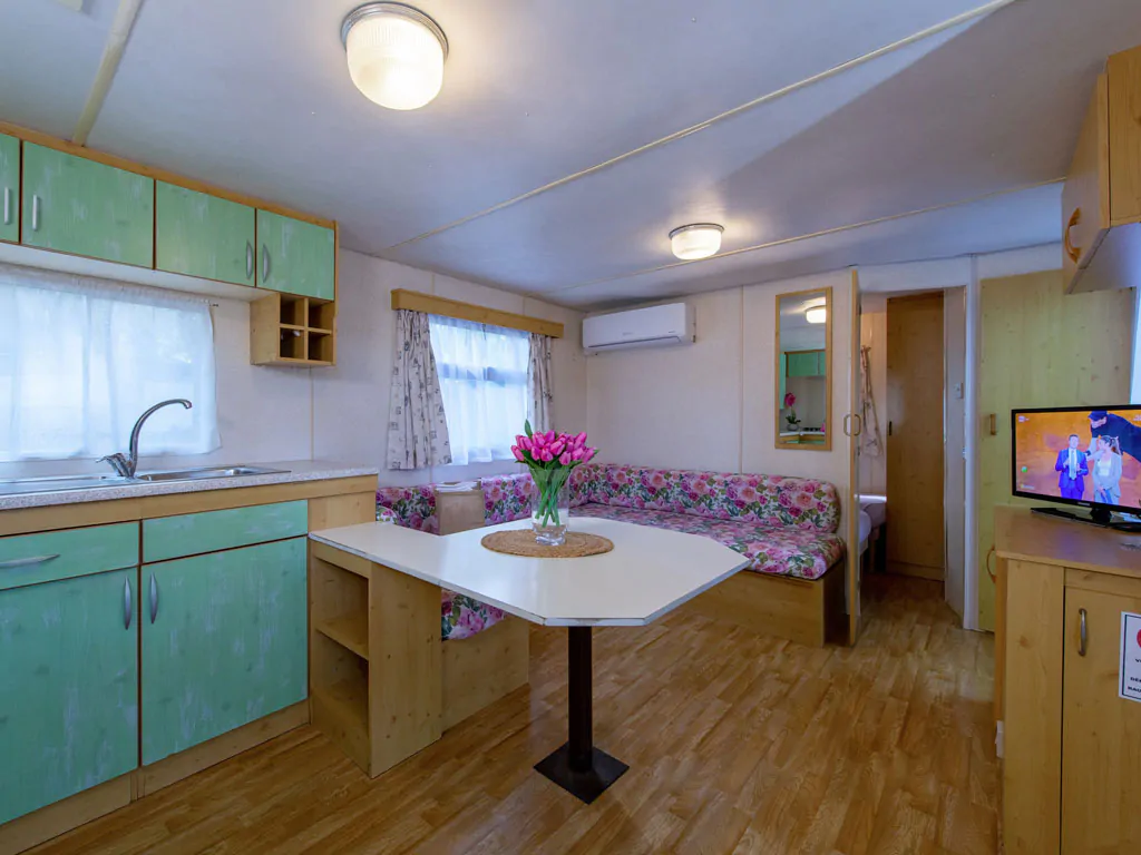 camping-village-punta-navaccia-mobile-home-interior-kitchen-and-dining-area-view