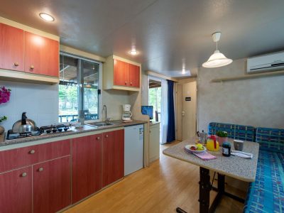 camping-village-punta-navaccia-mobile-home-superior-interior-kitchen-and-dining-table-vew